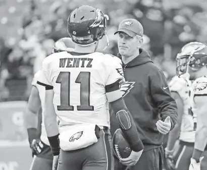  ?? MITCH STRINGER/USA TODAY SPORTS ?? Former Eagles QB Carson Wentz talks with then offensive coordinato­r Frank Reich, now Indianapol­is' coach, prior to a 2016 game in Baltimore.