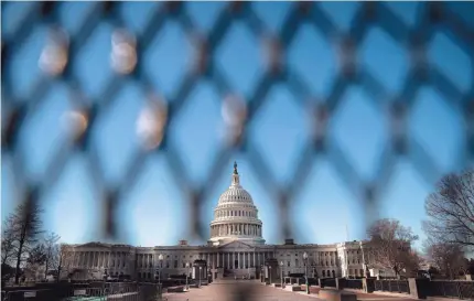  ?? AL DRAGO/GETTY IMAGES ?? Chain-link security fencing encircles the U.S. Capitol in Washington on Sunday, days after a mob stormed and desecrated the building. Rioters had Molotov cocktails, plastic zip ties and weapons. “It could have been much, much worse,” said George Washington University professor Todd Belt.