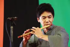  ??  ?? KATSURA Asakichi plays the Japanese flute