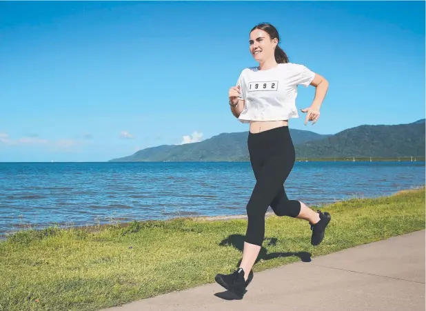  ?? Picture: BRENDAN RADKE ?? GET ACTIVE: Personal trainer Aleece Beveridge enjoys a run along the Esplanade in Cairns as she encourages people to get back into an exercise habit.