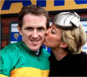  ?? AP ?? Chanelle plants a victory kiss on her champion jockey husband