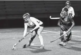  ?? PAUL W. GILLESPIE/CAPITAL GAZETTE ?? Severna Park’s Lila Slattery advances the ball in the first half Wednesday night against Old Mill in a Class 4A field hockey state semifinal game at Broadneck High School.