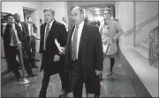  ?? AP/J. SCOTT APPLEWHITE ?? U.S. Rep. Bruce Poliquin (foreground, right), a Maine Republican, leaves Capitol Hill on Wednesday.