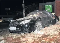  ?? PHOTO: REUTERS ?? Crunched . . . A damaged car and debris on a street at an emergency assembly point in PortofSpai­n, Trinidad and Tobago, yesterday.