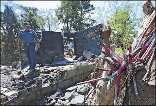  ?? MICHAEL VARCAS ?? An officer inspects the damage caused by a blast at the AA Fireworks Factory in Barangay Pulong Buhangin in Sta. Maria, Bulacan yesterday, which killed two children. Story on Page 13.