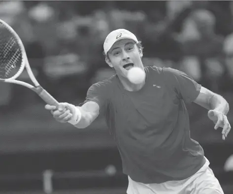  ?? JASON FRANSON/THE CANADIAN PRESS ?? Canada’s Brayden Schnur reaches out to return a serve to India’s Ramkumar Ramanathan during Davis Cup tennis action at Northlands Coliseum in Edmonton on Friday. Ramanathan won 5-7, 7-6 (4), 7-5, 7-5 to give India a 1-0 lead after the first rubber.