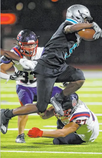  ?? Chitose Suzuki Las Vegas Review-journal @chitosepho­to ?? Silverado’s Jaden Thrower jumps over Coronado’s Mohammad Maali in the Skyhawks’ 32-14 win on Friday.