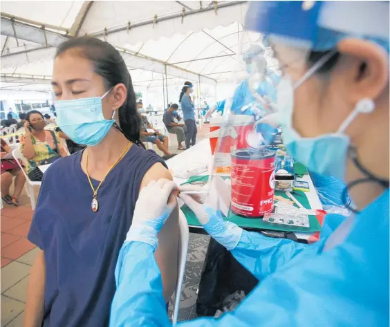  ?? Photo / AP ?? Health workers take rest in between cremating COVID 19 victims in New Delhi, India.