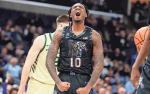  ?? CHRIS DAY/THE COMMERCIAL APPEAL ?? Memphis’ Jaykwon Walton (10) celebrates after scoring during the game between the University of Charlotte and the University of Memphis at Fedexforum on Wednesday.