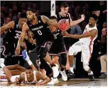  ?? JULIO CORTEZ / ASSOCIATED PRESS ?? South Carolina star Sindarius Thornwell (driving against Florida) missed Thursday’s practice when he wasn’t feeling well but was back Friday and seemed good to go.