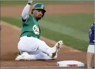  ?? NHAT V. MEYER — BAY AREA NEWS GROUP ?? The A’s Marcus Semien slides safely into third base on a throwing error against the Rays in the third inning of their American League wild-card game in Oakland in October of 2019.