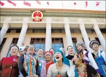  ?? — Reuters ?? Women delegates wearing traditiona­l costumes pose near the Great Hall of the People in Beijing.