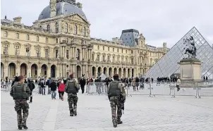  ??  ?? French soldiers patrol near the Louvre Museum in Paris.