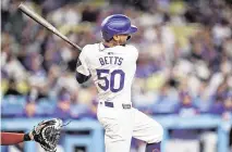  ?? GARY A. VASQUEZ USA TODAY Sports ?? Dodgers shortstop Mookie Betts hits an RBI double against the Washington Nationals during the second inning on Tuesday in Los Angeles.