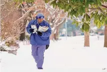  ?? ?? U.S. Postal Services mail carrier RayShawn Riley delivers mail in North Texas.