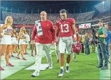  ?? Ap-vasha Hunt ?? Alabama quarterbac­k Tua Tagovailoa (13) walks off the field hurt against Tennessee during the first half of an NCAA college football game Saturday in Tuscaloosa, Ala.