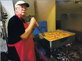  ?? RICH FREEDMAN — TIMES-HERALD ?? Terry Abreau Oorks on Sunday’s meal on beHalf of tHe SparroO Project at First Baptist CHurcH in doOntoOn Vallejo.