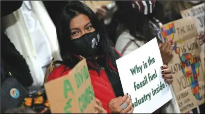  ?? ASSOCIATED PRESS ?? Youth climate activists protest that representa­tives of the fossil fuel industry have been allowed inside the venue during the COP26 UN Climate Summit in Glasgow, Scotland, Thursday.