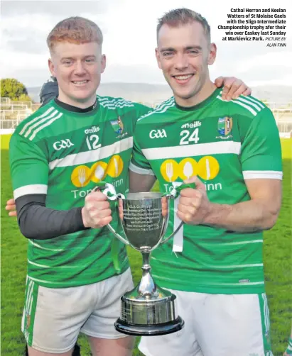  ?? PICTURE BY ALAN FINN ?? Cathal Herron and Keelan Watters of St Molaise Gaels with the Sligo Intermedia­te Championsh­ip trophy afer their win over Easkey last Sunday at Markievicz Park.