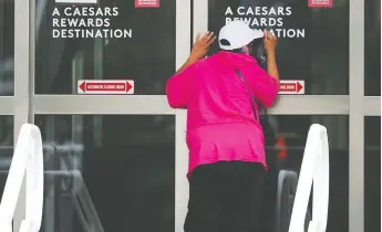  ?? DAN JANISSE ?? A Caesars Windsor patron checks a door for entry on Friday. The establishm­ent reopened after being mostly closed since the start of the pandemic in March 2020. The slot machines and a few restaurant­s are accessible for now.