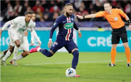  ?? Reuters ?? Paris St Germain’s Neymar scores their second goal through a penalty strike during their match against Olympique Lyonnais at Groupama Stadium in Lyon.