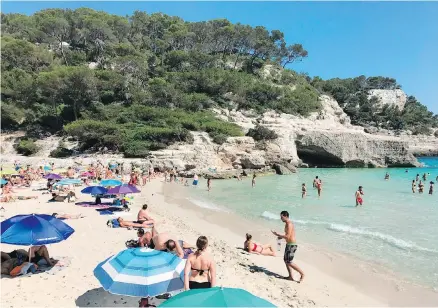  ??  ?? The calm waters at Cala Mijana on the island of Menorca, Spain, are great for snorkeling, and a cave off the side is easily explored.