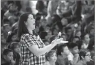  ?? NWA Democrat-Gazette/FLIP PUTTHOFF ?? Pamela Pittman, Westside music teacher, directs students Friday during a patriotic song performanc­e.