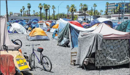  ?? Ross D. Franklin The Associated Press ?? A homeless encampment is shown in Phoenix in 2020. On Thursday, a federal judge temporaril­y halted the city from conducting encampment sweeps after a lawsuit by the ACLU of Arizona.