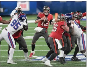  ?? (AP/Bill Koustroun) ?? Tampa Bay quarterbac­k Tom Brady (12) looks to pass in the Buccaneers’ 25-23 victory Monday night against the New York Giants. Brady threw for 279 yards and two touchdowns.