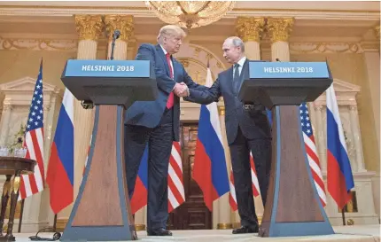  ?? PABLO MARTINEZ MONSIVAIS/AP ?? President Donald Trump and Russian President Vladimir Putin shake hands in Helsinki.