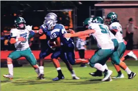  ?? Photos by FRANK CROWE / For the Calhoun Times ?? ( Gordon Central’s Gauge Giddens (22) weaves through Murray County defenders for a touchdown run in the third quarter. ( Gordon Central’s Cameron Pierce (1) fights for extra yards in the first half.