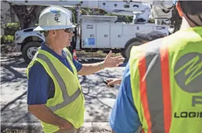  ?? ROBERT BUMSTED/AP ?? Florida Power and Light CEO Eric Silagy visits workers restoring power in Naples, Fla., on Monday. Silagy says that he expects crews to be finished restoring power to habitable homes impacted by Hurricane Ian by the end of the week.