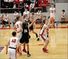  ?? MARK HUMPHREY ENTERPRISE-LEADER ?? Farmington senior James Payne gets a wide open layup in the half-court offense set up by teammate, Gavin Spurlock, who dishes out the assist. The Cardinals blasted Charleston, 88-45, in non conference boys basketball action on Tuesday, Dec. 8.