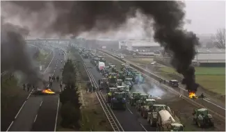  ?? ?? Farmers make barricades after blocking a highway during a protest near Mollerussa, northeast Spain, Tuesday, Feb. 6, 2024.