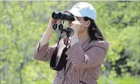  ?? JASON BAIN/EXAMINER ?? Peterborou­ghKawartha MP Maryam Monsef eyes marshland during a tour of the Kawartha Land Trust Dance Nature
Sanctuary on Preston Rd.