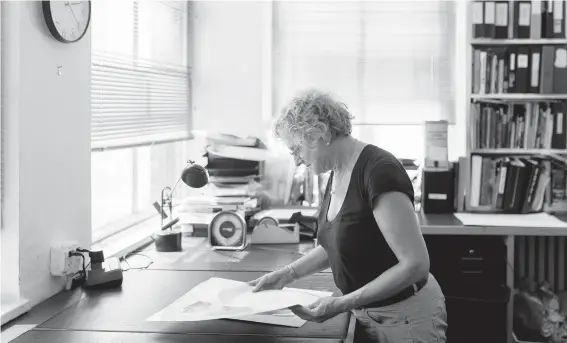  ?? JEENAH MOON/THE NEW YORK TIMES PHOTOS ?? Jane Kallir, of Kallir Research Institute, holds a copy of Egon Schiele’s “Standing Girl” in August. Discredite­d works can resurface again and again.