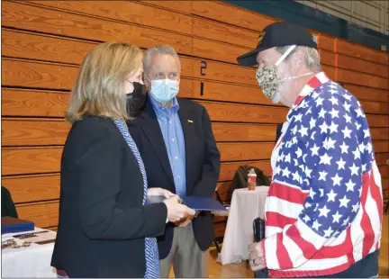  ?? RACHEL RAVINA — MEDIANEWS GROUP ?? U.S. Rep. Madeleine Dean, D-4th Dist., stands with her brother, Bob, left, as she gives a commendati­on to Vietnam-era veteran Fred Rainer, of Lansdale, Sunday morning during a COVID-19vaccinat­ion clinic at North Penn High School.