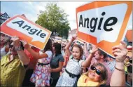  ?? RALPH ORLOWSKI / REUTERS ?? Supporters of German Chancellor Angela Merkel hold up placards during her inaugural election campaign rally in Seligensta­dt near Frankfurt on Wednesday.