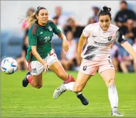  ?? Harry How Getty Images ?? MEXICO’S Nancy Antonio, left, and Angel City’s Megan Reid pursue the ball during an exhibition Monday at Banc of California Stadium. Mexico won 2-0.