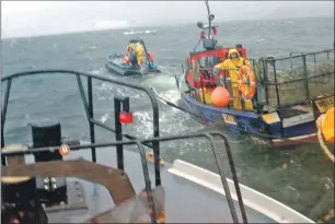  ??  ?? The volunteer crew of Oban lifeboat manage to secure a line to the stricken fishing vessel.