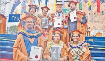  ?? Picture: JONACANI LALAKOBAU ?? Graduates pose for the camera after the graduation ceremony.