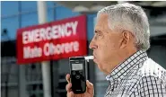  ?? PHOTO: KEVIN STENT/FAIRFAX NZ ?? Wellington Hospital Charity chairman Bill Day demonstrat­es a breathalys­er given to the hospital in 2015.