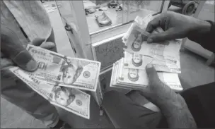  ??  ?? Iranian rials, U.S. dollars and Iraqi dinars are seen at a currency exchange shop in Basra, Iraq November 3, 2018. Picture taken November 3, 2018.