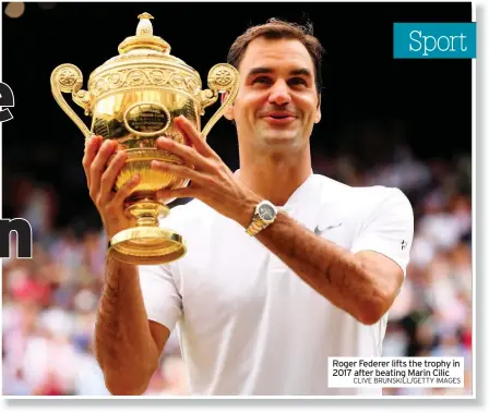  ?? CLIVE BRUNSKILL/GETTY IMAGES ?? Roger Federer lifts the trophy in 2017 after beating Marin Cilic