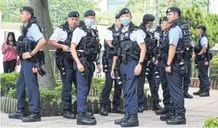  ?? AFP ?? Police patrol in the Causeway Bay shopping district of Hong Kong yesterday, close to the venue where Hong Kong people traditiona­lly gather annually to mourn the victims of China’s Tiananmen Square crackdown in 1989.