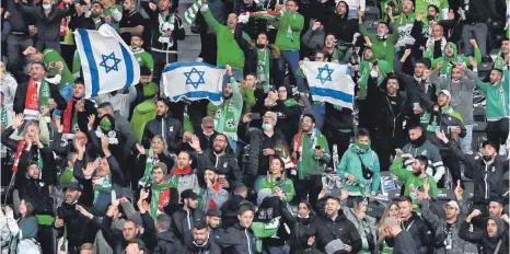  ?? FOTO: MATTHIAS KOCH/DPA ?? Anhänger von Maccabi Haifa zeigen auf der Tribüne israelisch­e Flaggen. Union-Fans sollen sie im Olympiasta­dion antisemiti­sch beleidigt haben.