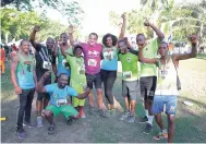  ??  ?? Dr Chris Tufton (centre), minister of health, sharing a moment with the Advanced Integrated Systems (AIS) team at Everyone’s A Winner/Running Events 5K/10K Run/Walk held last month.