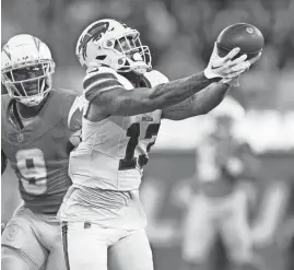  ?? ASHLEY LANDIS/AP ?? Bills wide receiver Gabe Davis catches a touchdown pass against Chargers linebacker Kenneth Murray Jr. on Saturday.