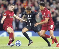  ?? AP ?? Liverpool’s Jordan Henderson (left) and Trent Alexander-Arnold (right) challenge PSG’s Neymar during the Champions League Group C match at Anfield yesterday. Liverpool won 3-2.