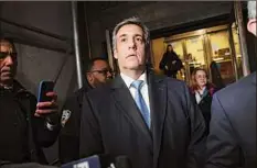  ?? Spencer Platt / Getty Images ?? Former Donald Trump lawyer and loyalist Michael Cohen walks out of a Manhattan courthouse after testifying before a grand jury on Monday in New York City. The grand jury is investigat­ing payments Cohen arranged and made on behalf of the former president.